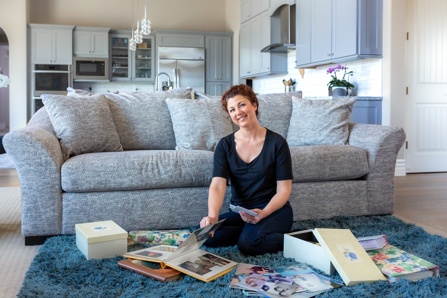 photo of natalie minor in the living room organizing photos